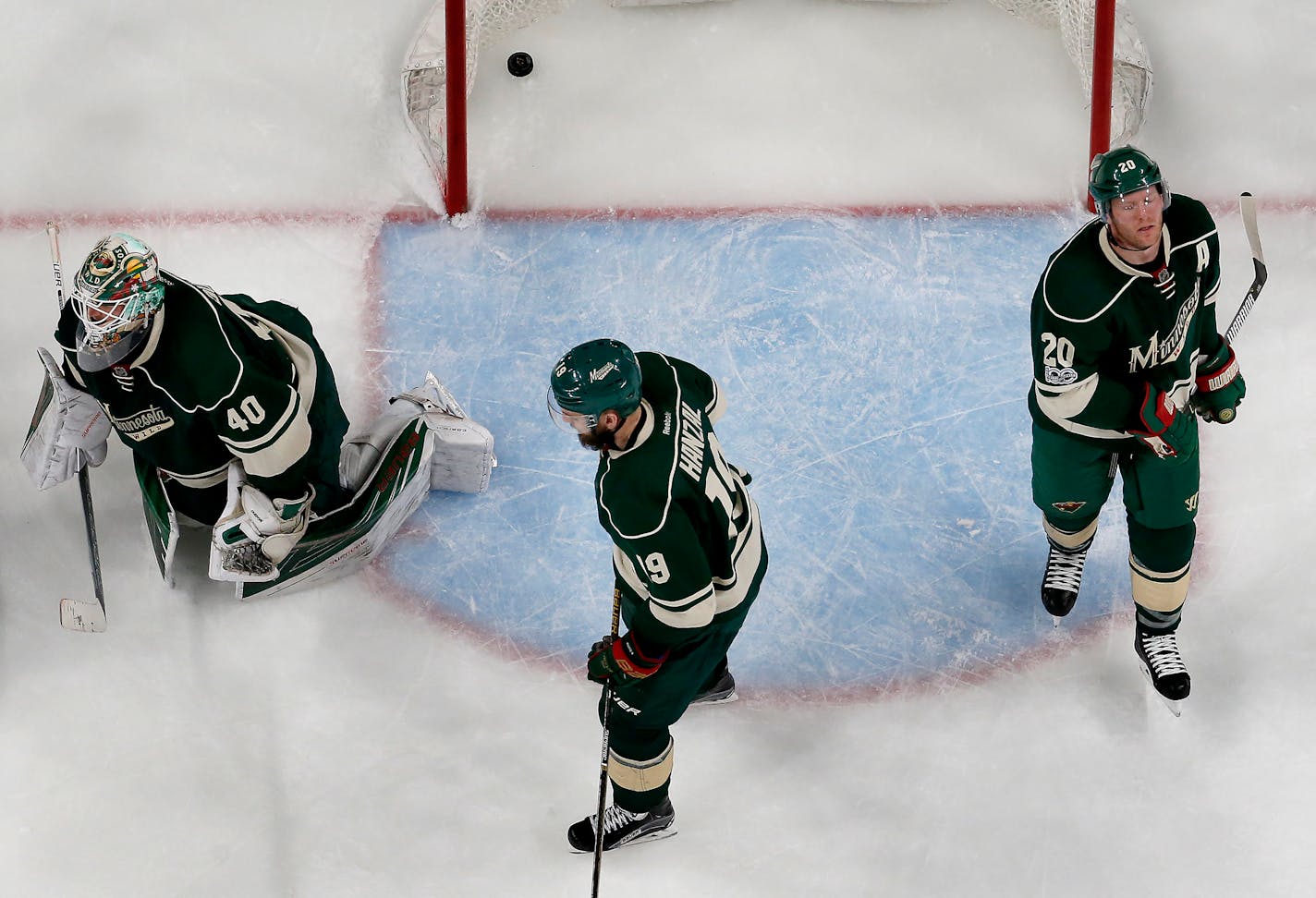 Wild players Devan Dubnyk (40), Martin Hanzal (19) and Ryan Suter (20) -- with the puck from Magnus Paajarvi's series-clinching shot still in the net -- realize their season is over after a 4-3 overtime loss to the St. Louis Blues at Xcel Energy Center on Saturday. ] CARLOS GONZALEZ � cgonzalez@startribune.com - April 22, 2017, St. Paul, MN, Xcel Energy Center, NHL, Stanley Cup Playoffs, Game 5, Minnesota Wild vs. St. Louis Blues