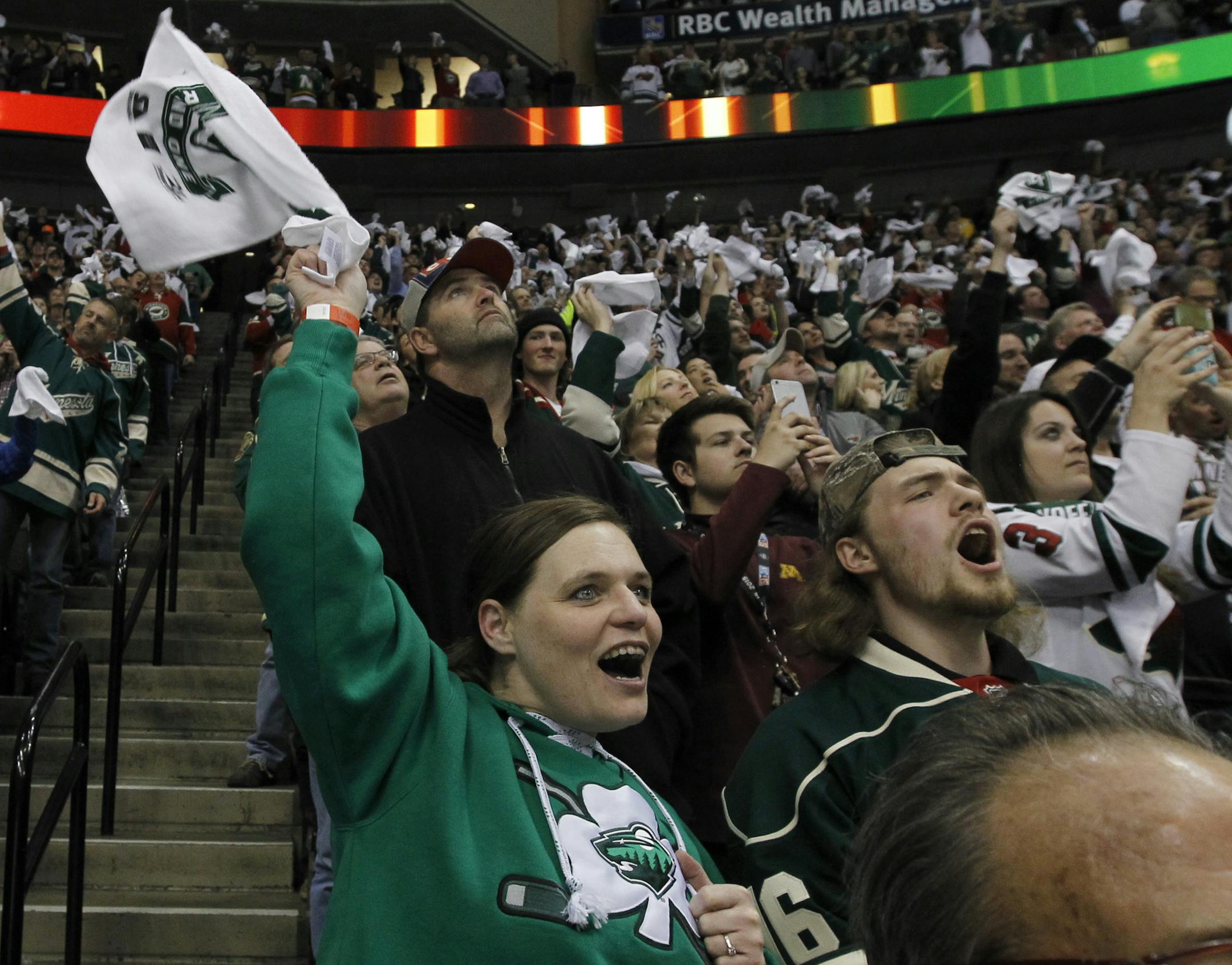 Minnesota Wild fans cheer after a goal by Minnesota Wild right wing Jason Pominville during the second period of Game 3 of an NHL hockey first-round playoff series game against the St. Louis Blues in St. Paul, Minn., Monday, April 20, 2015. (AP Photo/Ann Heisenfelt) ORG XMIT: OTKAH116