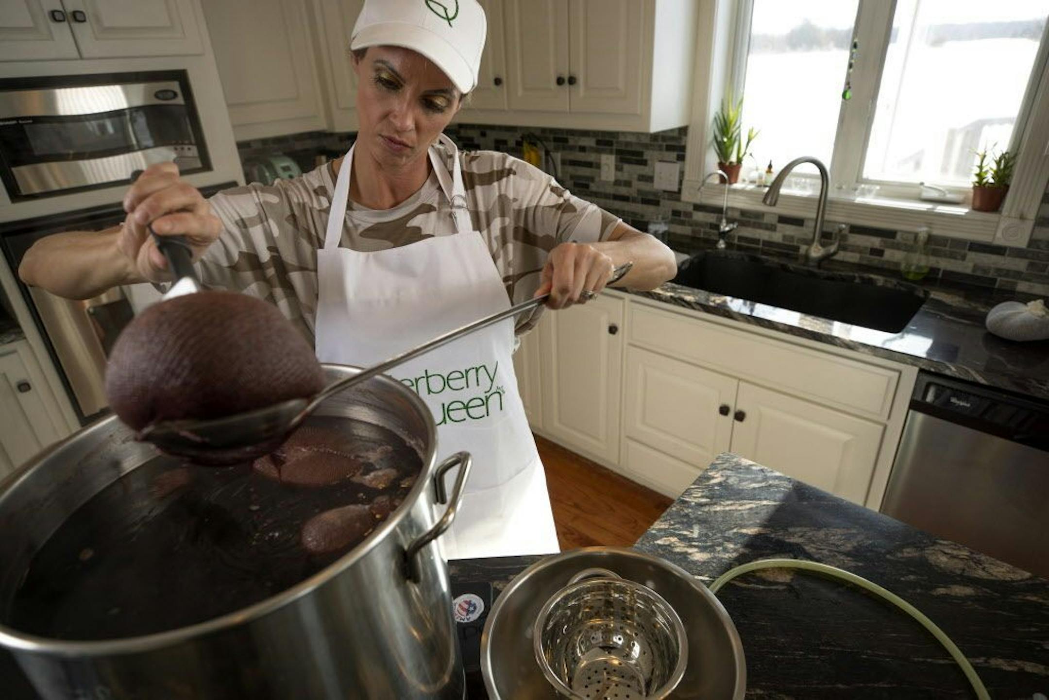 Lindsey Christianson, the "Elderberry Queen" made a batch of elderberry syrup in her home kitchen Wednesday Feb 28, 2018 in Ramsey, MN.