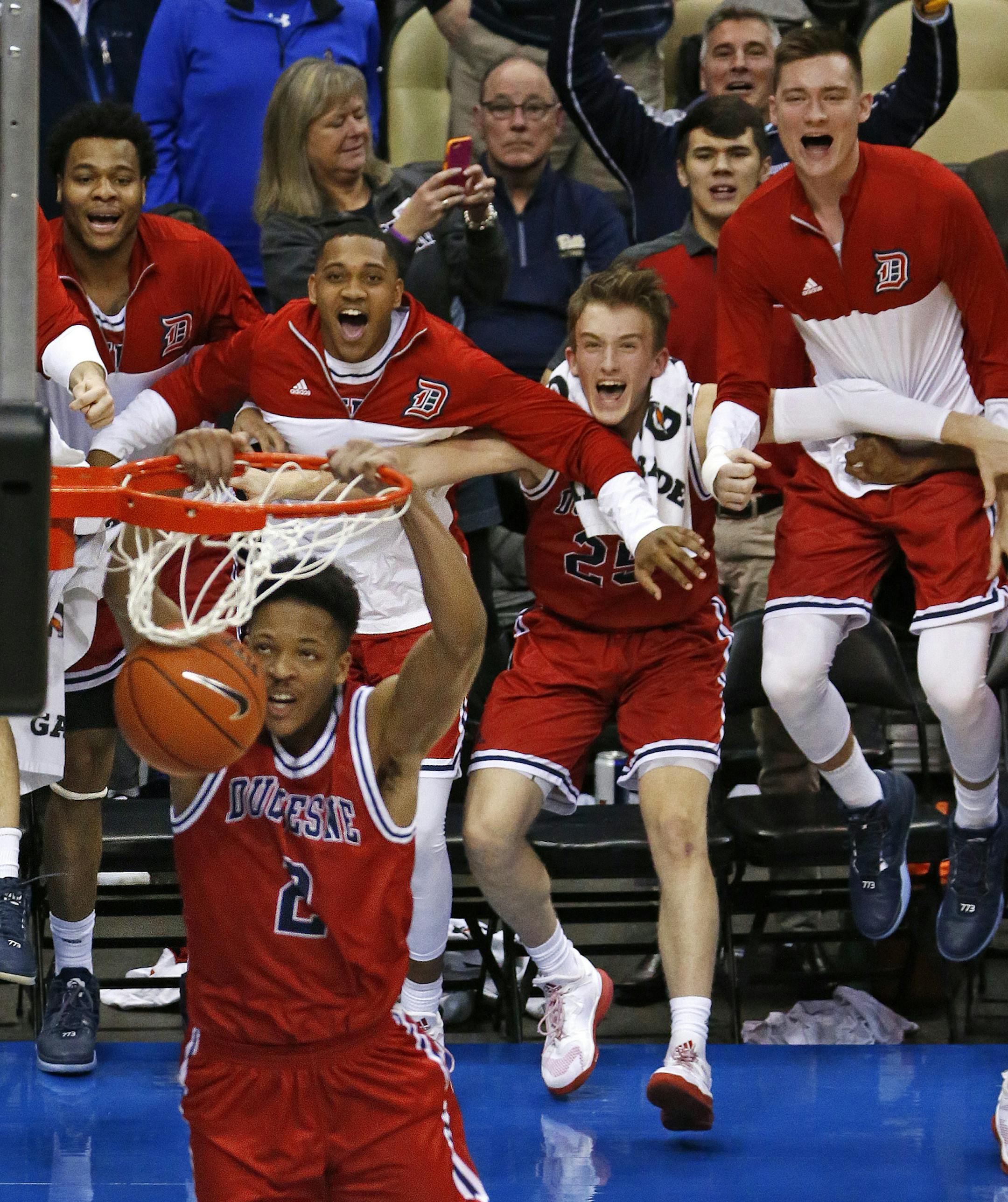 Duquesne forward Eric James (2) dunks the ball in the final minutes of an NCAA college basketball game against Pittsburgh in Pittsburgh, Friday, Dec. 2, 2016. Duquesne won 64-55. (AP Photo/Gene J. Puskar)
