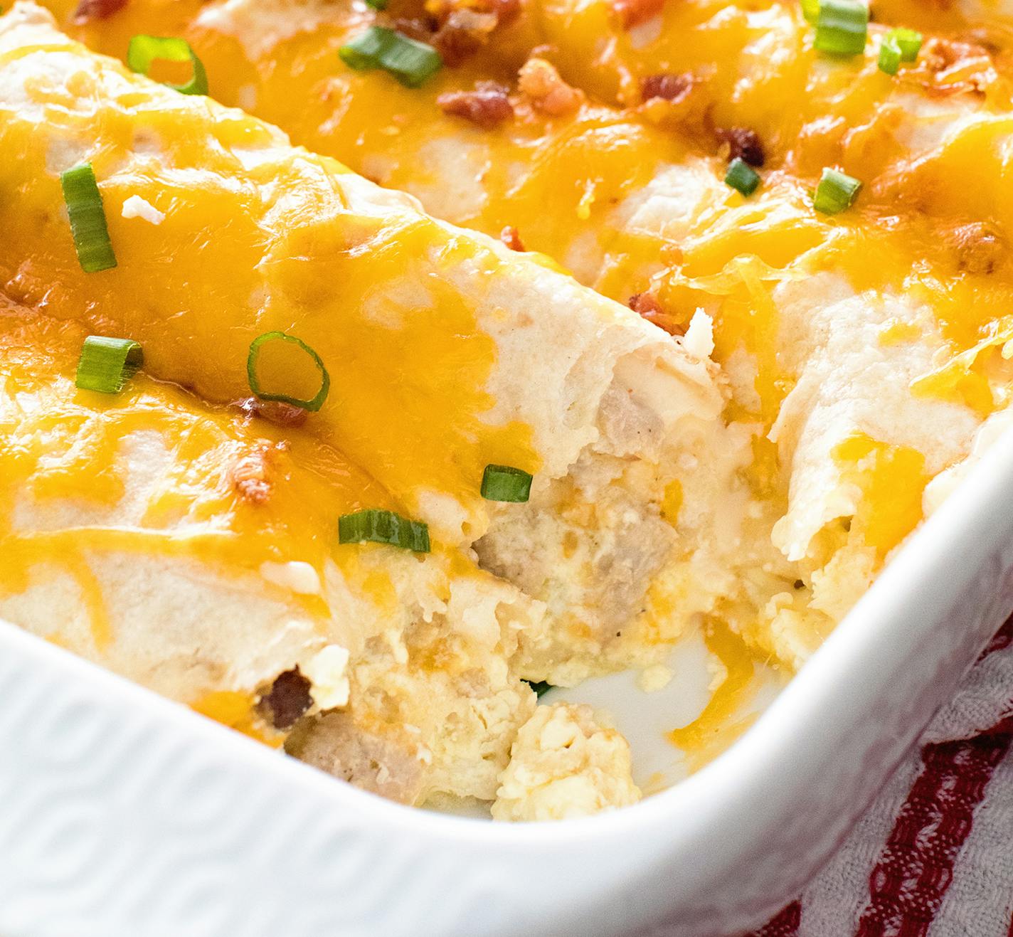 Breakfast Enchiladas topped with cheese, bacon and green onions are among the recipes in Julie Evink's book "Julie's Eats & Treats Cookbook."