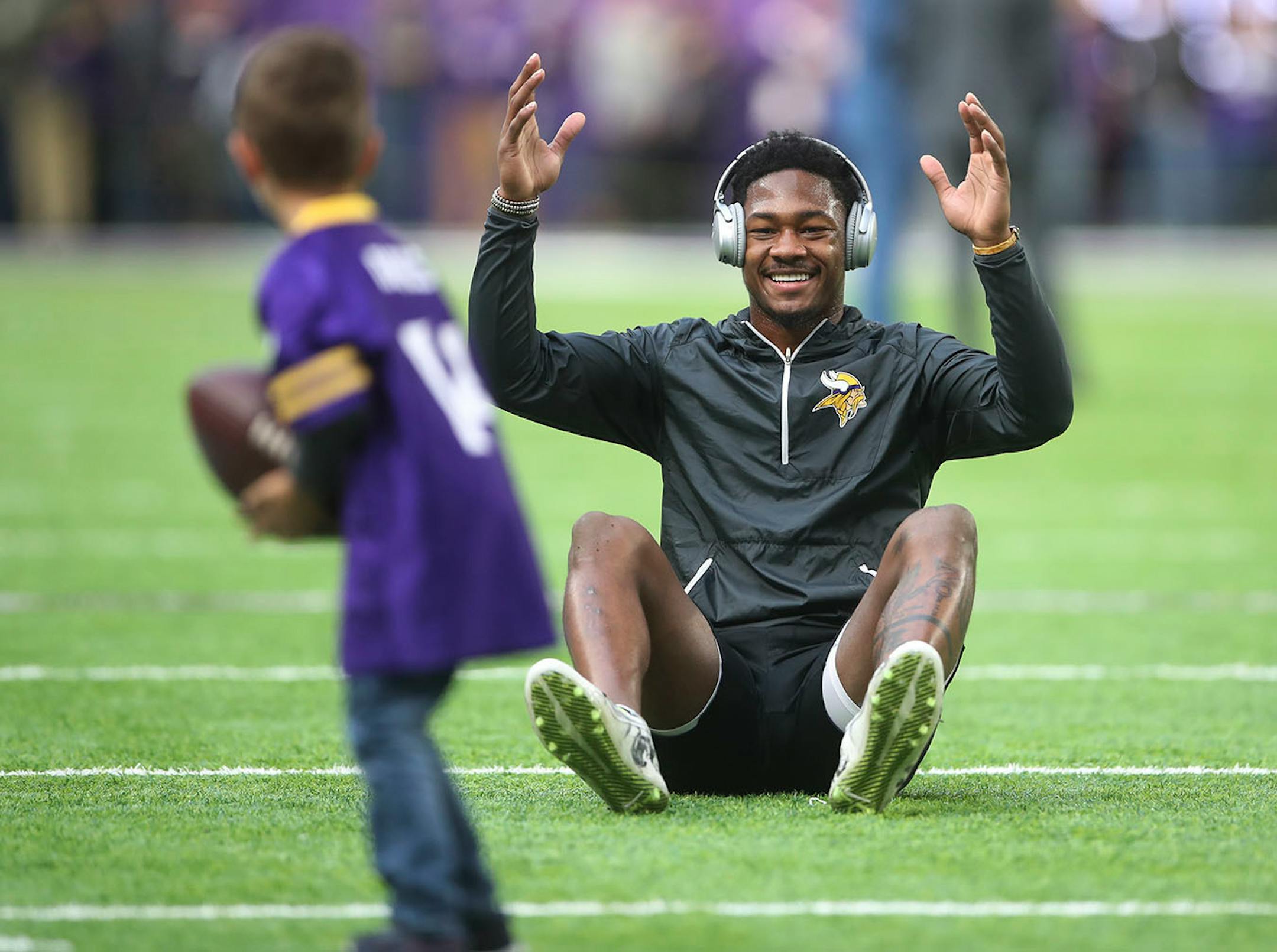 Minnesota Vikings wide receiver Stefon Diggs (14) reacts after Wyatt Ficken 5, of Eden Prairie caught a pass from him during warmups at U.S. Bank Stadium Sunday November 19, 2017 in Minneapolis, MN.