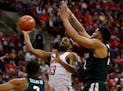Ohio State guard JaQuan Lyle went up to shoot between Michigan State guards Alvin Ellis III, left, and Miles Bridges during the second half Sunday.