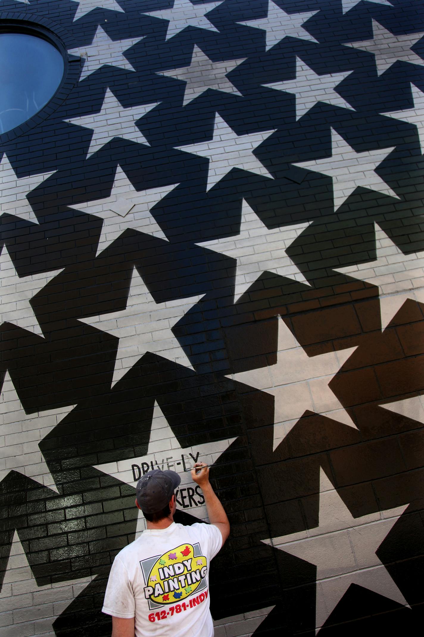 Workers repainted the famed wall of stars with names of bands that have played First Ave.