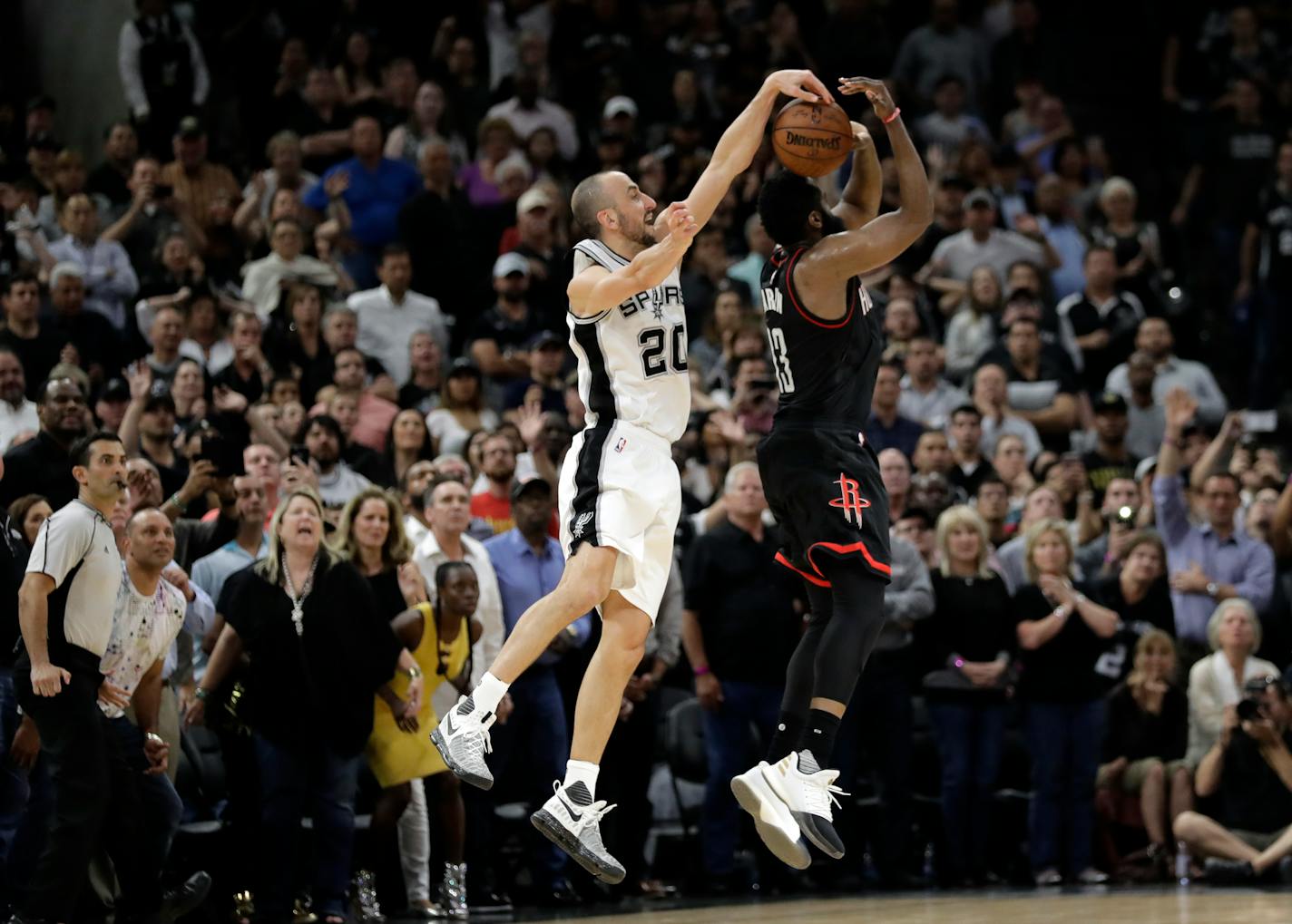 San Antonio Spurs' Manu Ginobili (20) of Argentina blocks Houston Rockets' James Harden three-point shot attempt in the final seconds of overtime of Game 5 in a second-round NBA basketball playoff series, Tuesday, May 9, 2017, in San Antonio. San Antonio won 110-107. (AP Photo/Eric Gay)