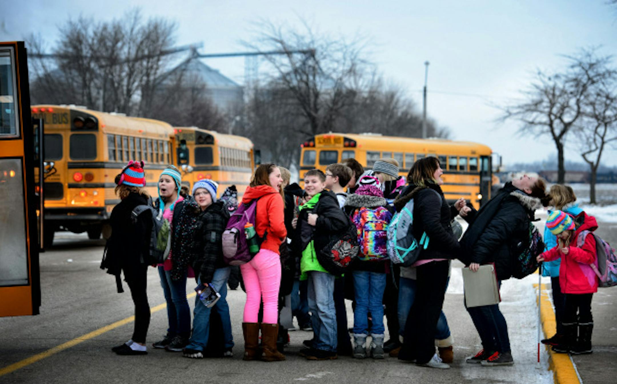 MACCRAY students head to the busses at four o'clock at the end of the day.  Four day weeks have days that start 30 minutes earlier and end 30 minutes later than 5-day a week students.  The high school is a hub for busses from the district's two elementary schools to make bus routes more efficient throughout the district.       ]   GLEN STUBBE * gstubbe@startribune.com   Wednesday, December 17, 2014   A fight is brewing here in this small pocket of southwestern Minnesota between a handful of rural school districts and the state. At issue is control over their innovative four-day school week, a popular schedule with both students, parents and teachers. Born out of financial necessity during leaner times, the four-day calendar has saved rural schools money on busing, heating and other administrative costs. School education officials, however, have ordered districts such as Maynard-Clara City-Raymond in west central Minnesota.