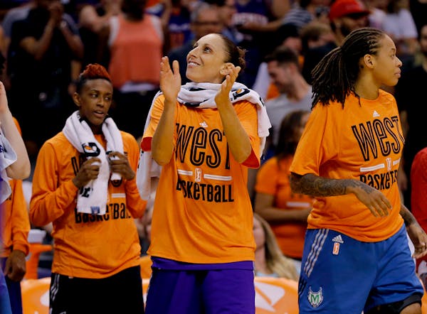 West's Diana Taurasi, of the Phoenix Mercury, applauds as time expires after the WNBA All-Star basketball game, Saturday, July 19, 2014, in Phoenix. T