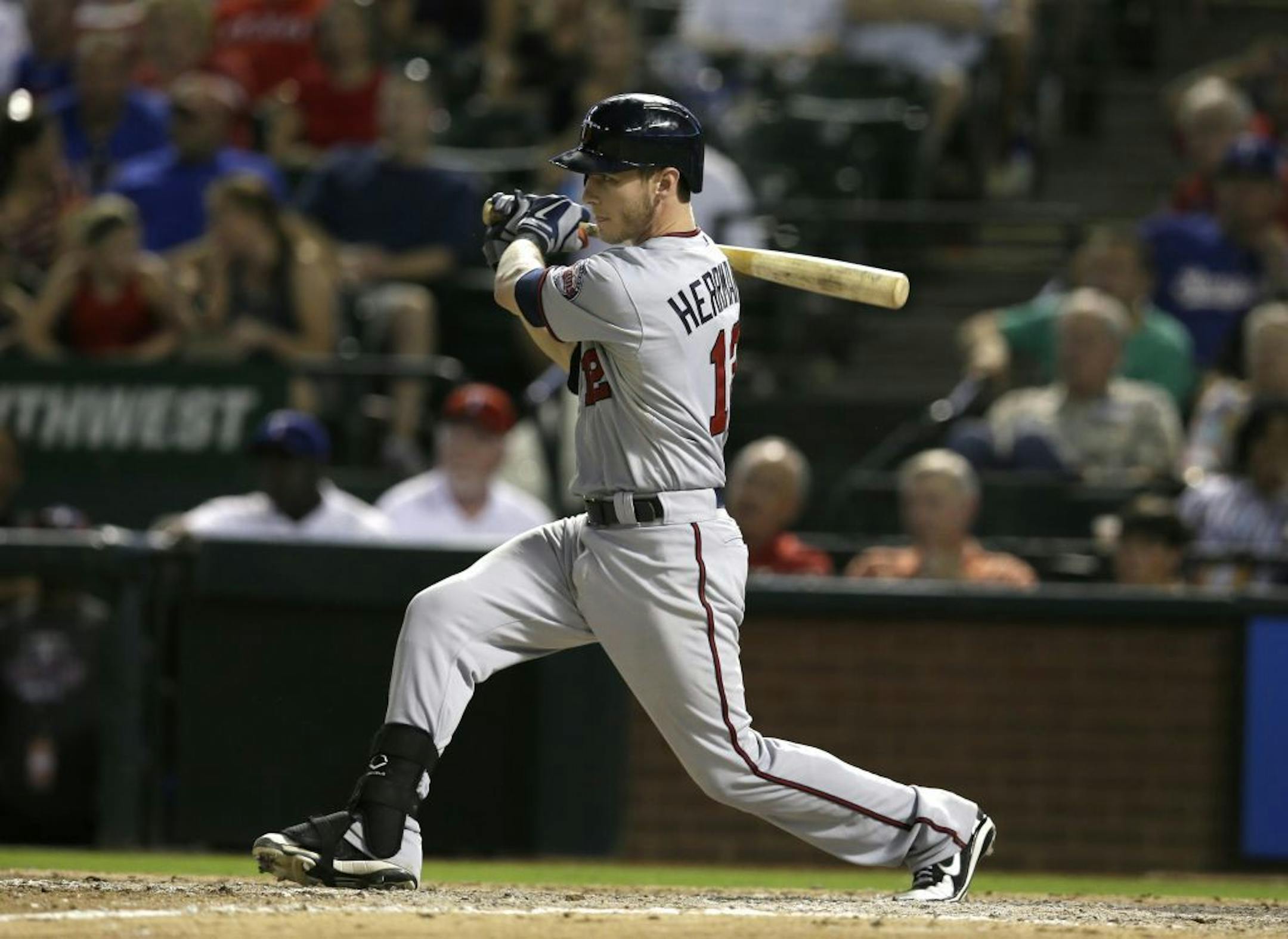 Minnesota Twins catcher Chris Herrmann (12) at bat in the ninth inning of a baseball game against the Texas Rangers, Friday, Aug. 30, 2013, in Arlington, Texas. The Twins won 3-2.