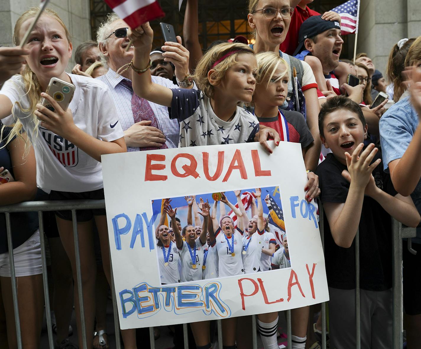 Fans and players celebrate the U.S. Women's Soccer Team winning the 2019 World Cup during a 'Canyon of Heroes' ticker tape parade in Lower Manhattan