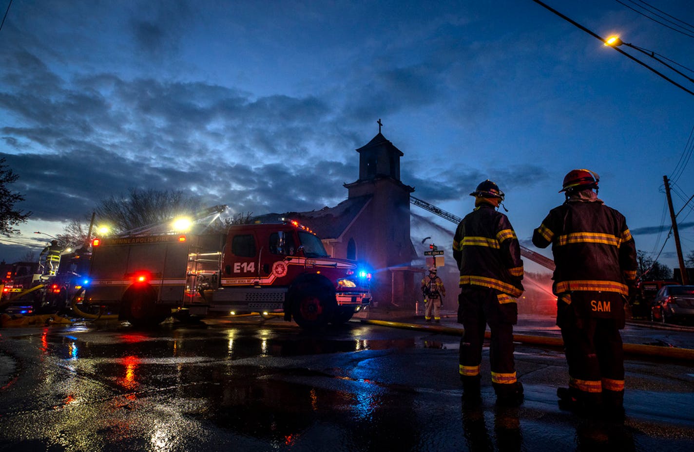 Firefighters worked on putting out a fire at the Sacred Heart of Jesus church in Northeast Minneapolis.