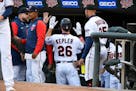 Minnesota Twins' Max Kepler, left, celebrates with his teammates after hitting a home run against Detroit Tigers pitcher Michael Pineda during the sec