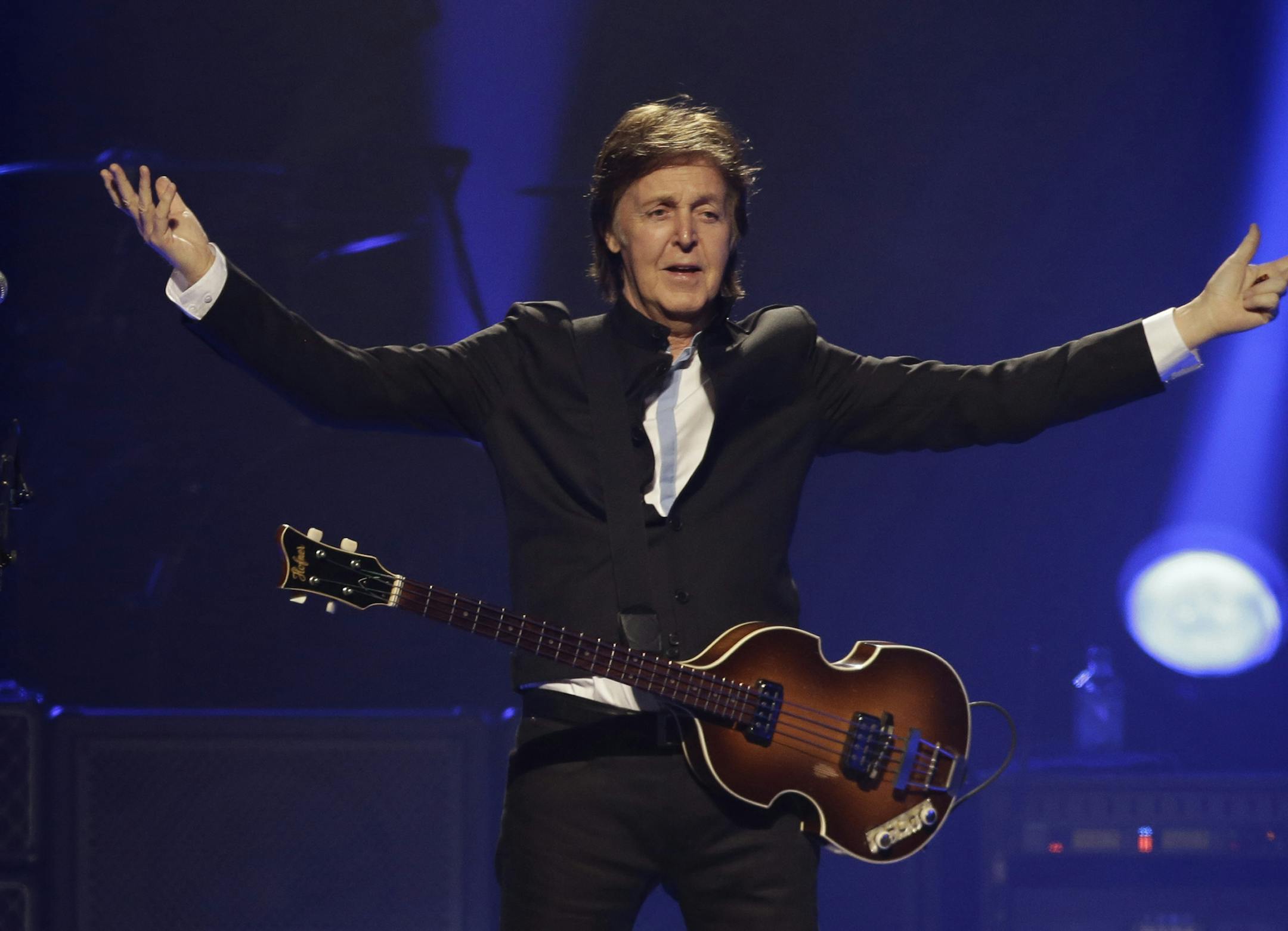 FILE - In this Saturday, May 18, 2013 file photo, Paul McCartney performs during the first U.S concert of his "Out There" tour, in Orlando, Fla. McCartney made his first visit to the one-time home of the King of Rock 'N' Roll and left a gift behind. According to the official Twitter account of the former Beatle, McCartney dropped a personal guitar pick on Elvis Presley's grave, Sunday, May 26, 2013, and said it was ‚Äúso Elvis can play in heaven." (AP Photo/John Raoux, File) ORG