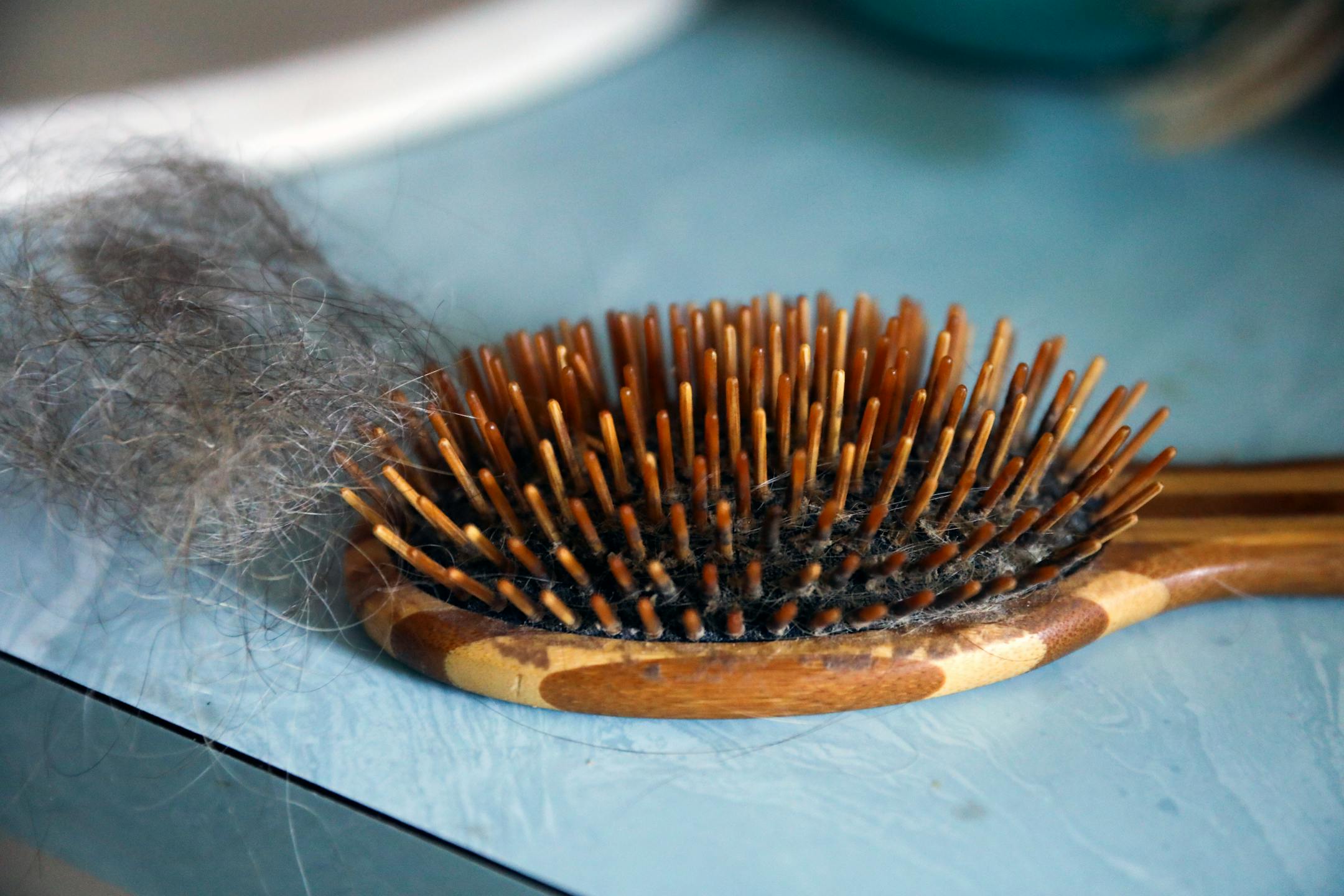 Annrene Rowe's hairbrush at her home in Anna Maria, Fla., on Sept. 18, 2020. Rowe was hospitalized for 12 days with coronavirus symptoms earlier this year; since then, she has noticed her hair falling out in clumps.(Eve Edelheit/The New York Times)