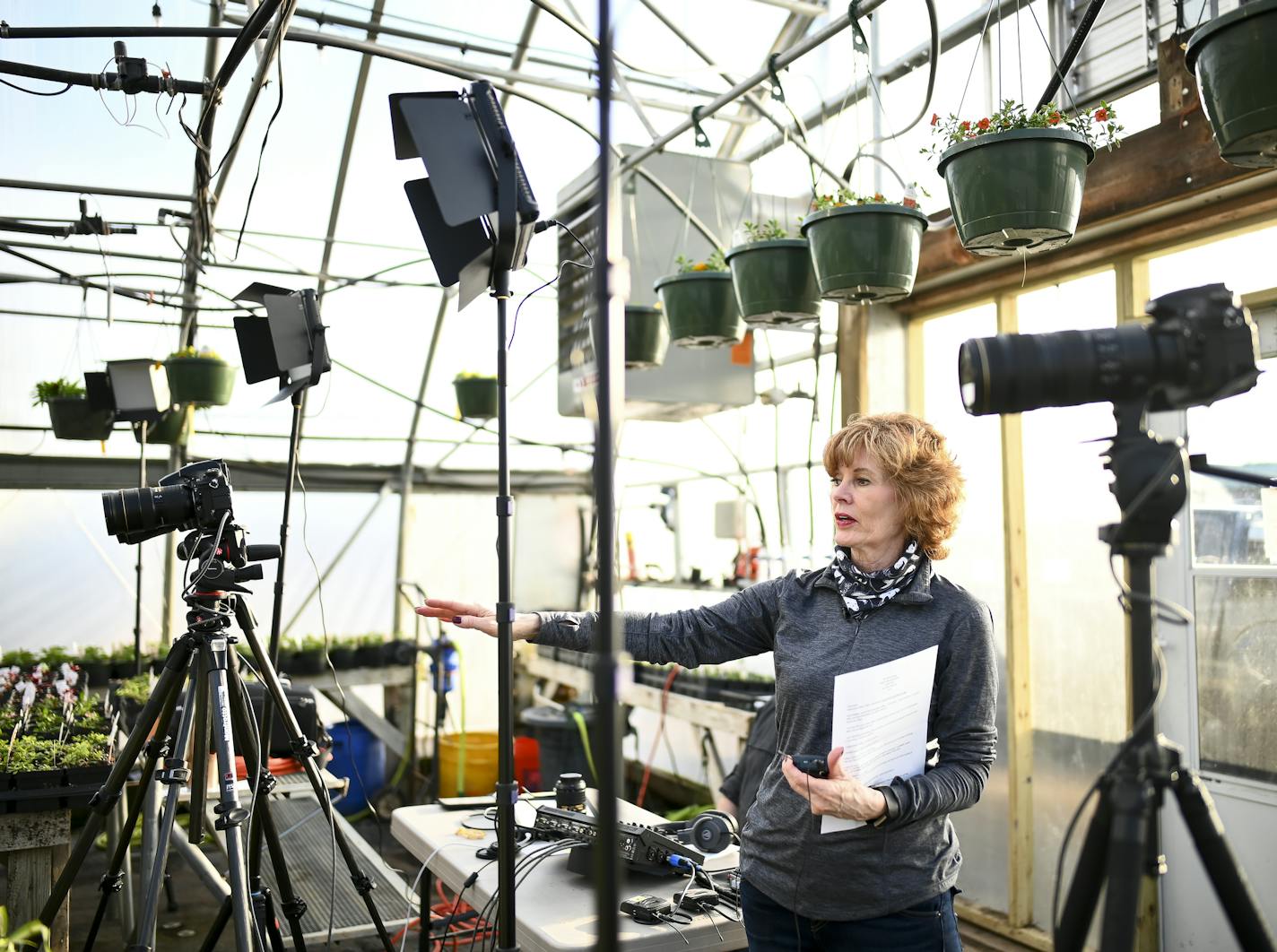 Diana Pierce worked with partner and "What's Next?" technical director Scott Bemman to set up for a videocast from Heidi's GrowHaus in Corcoran.