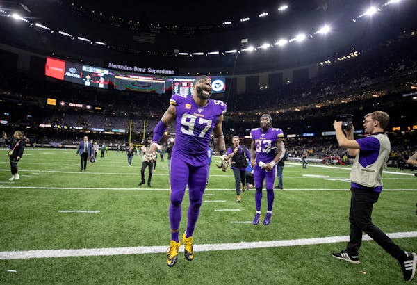 Minnesota Vikings defensive end Everson Griffen (97) and running back Dalvin Cook (33) celebrated the overtime win.] Jerry Holt • Jerry.Holt@startri