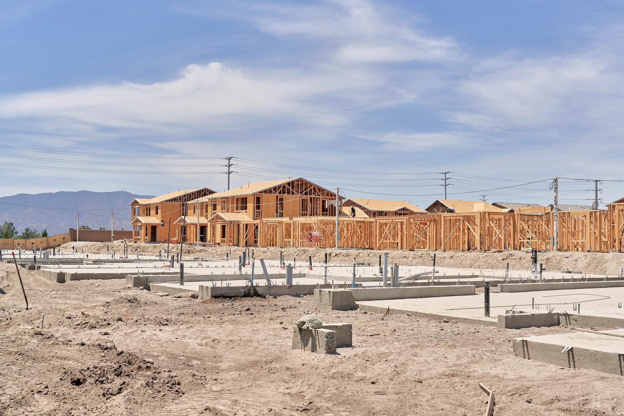 FILE — Houses under construction at The Preserve at Chino, a housing development in Chino, Calif., on July 21, 2022. "You'd think we could build much more, much faster, for less money, than in the past. But we can't. Or, at least, we don't," writes New York Times columnist Ezra Klein. (Philip Cheung/The New York Times)