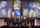 Members of the NASCAR Hall of Fame stand on stage at the closing of the 2015 induction ceremony, Friday, Jan. 30, 2015, in Charlotte, N.C. (AP Photo/N