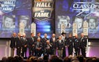 Members of the NASCAR Hall of Fame stand on stage at the closing of the 2015 induction ceremony, Friday, Jan. 30, 2015, in Charlotte, N.C. (AP Photo/N