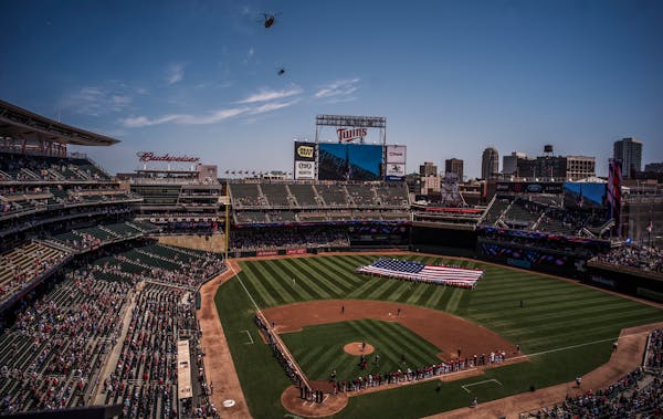 A pair of helicopters from the Minnesota National Guard flew over Target Field to commemorate Armed Forces Day before the Twins faced Baltimore Sunday