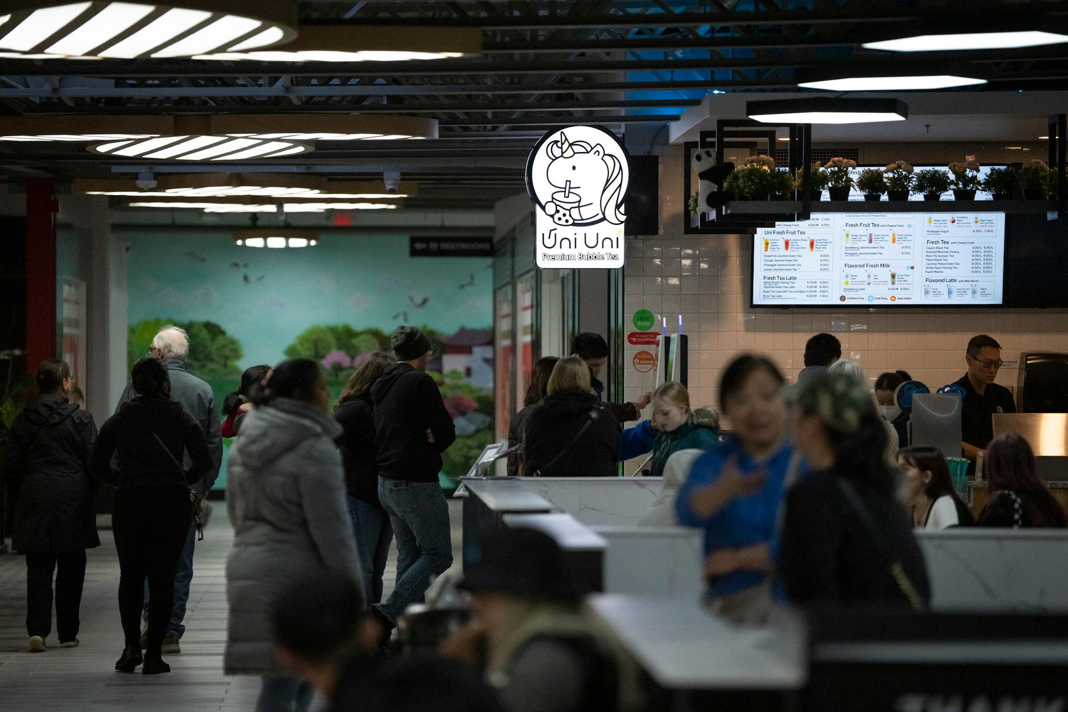 A consistent crowd of people filters through the soft opening for the new Asia Mall.