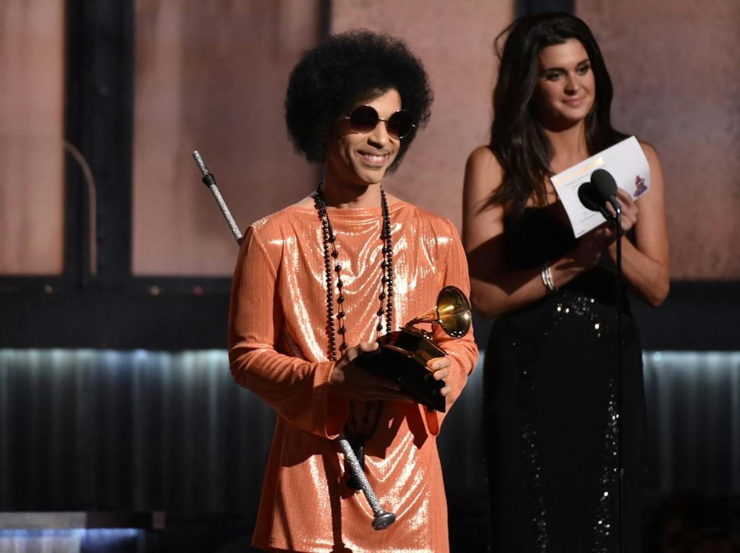 FILE - In this Feb. 8, 2015 file photo, Prince presents the award for album of the year at the 57th annual Grammy Awards in Los Angeles. Prince was the main attraction when he performed a concert early Saturday, Feb. 14, 2015 for a crowd that include Michael Jordan, Chris Rock, Questlove and Queen Latifah, who danced and sang to his rousing set in downtown New York City.