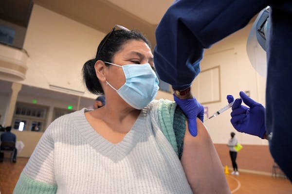 Lesbia Ruiz received her vaccination from Theresa Williams, a registered nurse, during a coronavirus vaccination drive for the Hispanic population at 