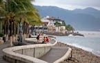 People enjoyed a seafront walkway the morning after Hurricane Patricia passed further south, sparing Puerto Vallarta, Mexico, Saturday, Oct. 24, 2015.