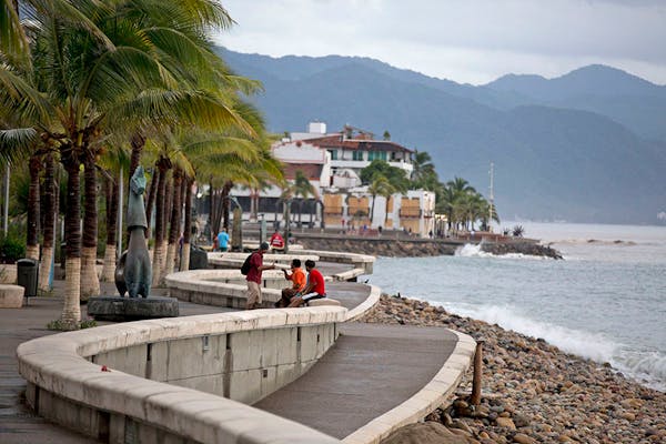 People enjoyed a seafront walkway the morning after Hurricane Patricia passed further south, sparing Puerto Vallarta, Mexico, Saturday, Oct. 24, 2015.