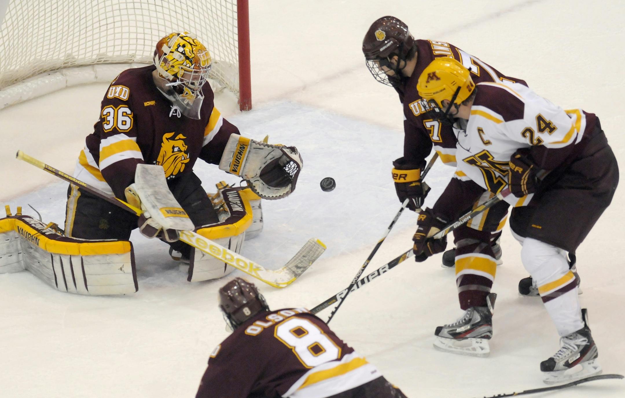 Minnesota-Duluth goalie Matt McNeely makes as save against Minnesota's Zach Budish.