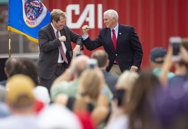 Former U.S. Representative Jason Lewis greeted Vice President Mike Pence after introducing him at the campaign event on Friday in Duluth. Lewis is cur