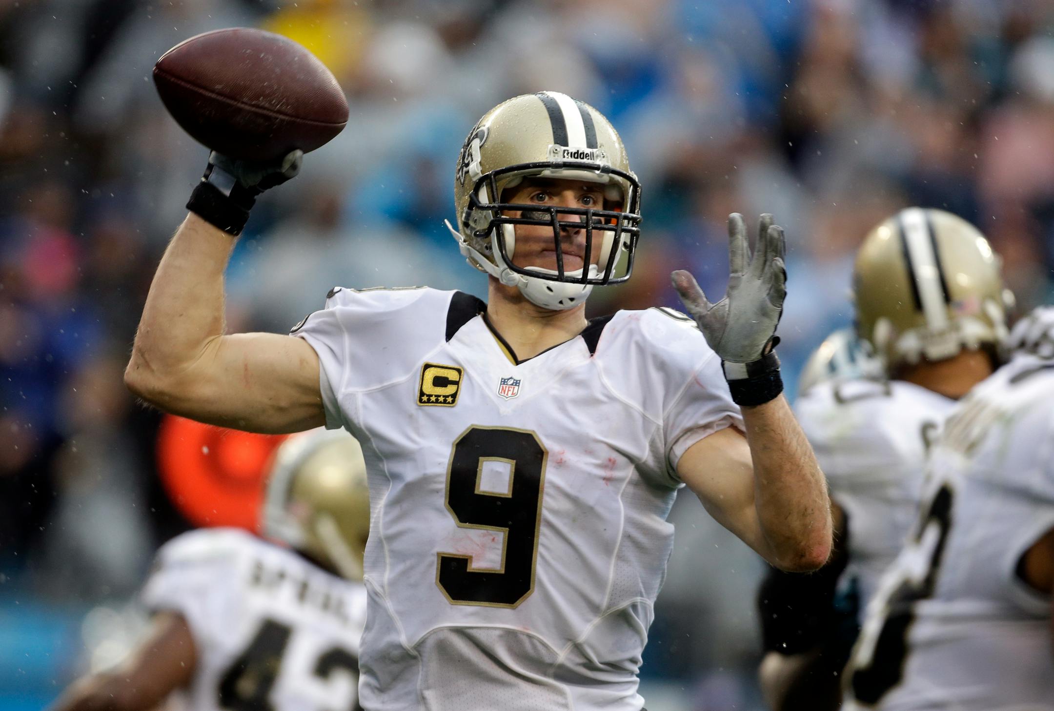 New Orleans Saints' Drew Brees (9) looks to pass against the Carolina Panthers in the second half of an NFL football game in Charlotte, N.C., Sunday, Dec. 22, 2013. (AP Photo/Bob Leverone)