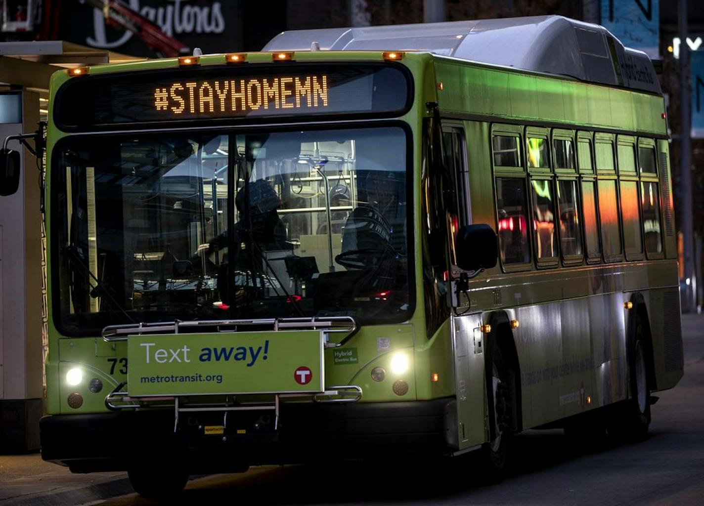 Metro Transit buses with the hashtag #STAYHOMEMN on Nicollet Mall in downtown Minneapolis on Monday evening.