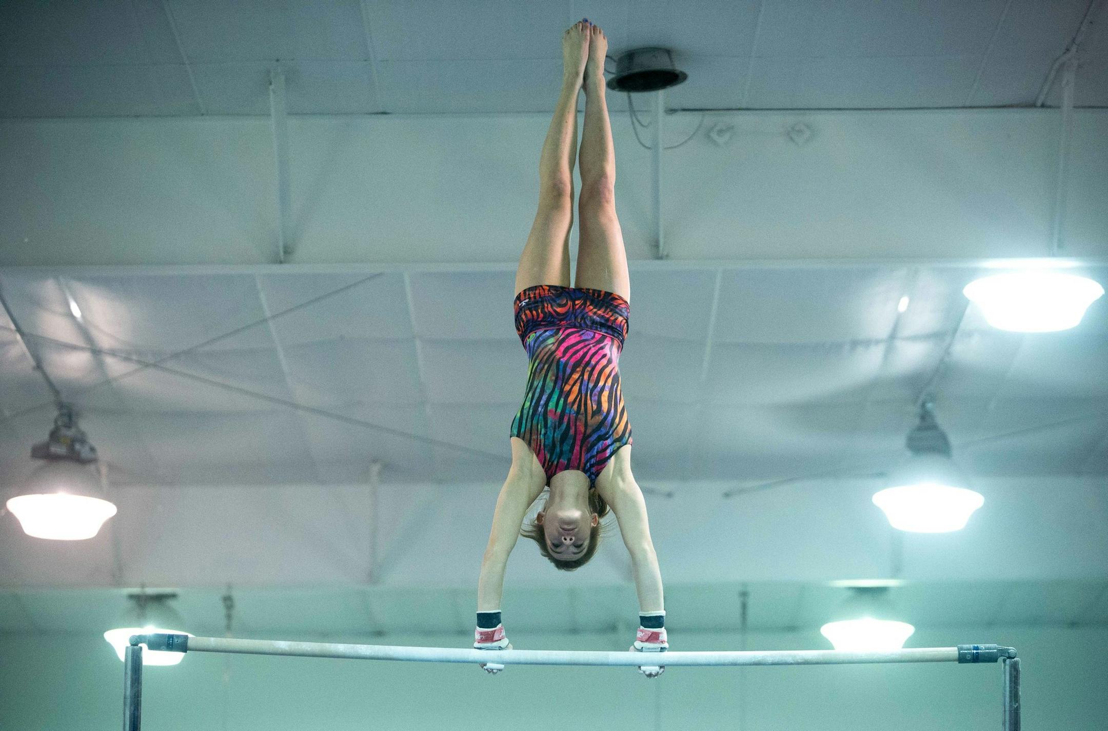 Northfield senior Bailey DuPay competes on the high bars during Saturday's meet. ] AARON LAVINSKY • aaron.lavinsky@startribune.com Northfield's gymnastics team holds an eight-team invitational at the Northfield Gymnastics Club Saturday, Dec. 6, 2014.