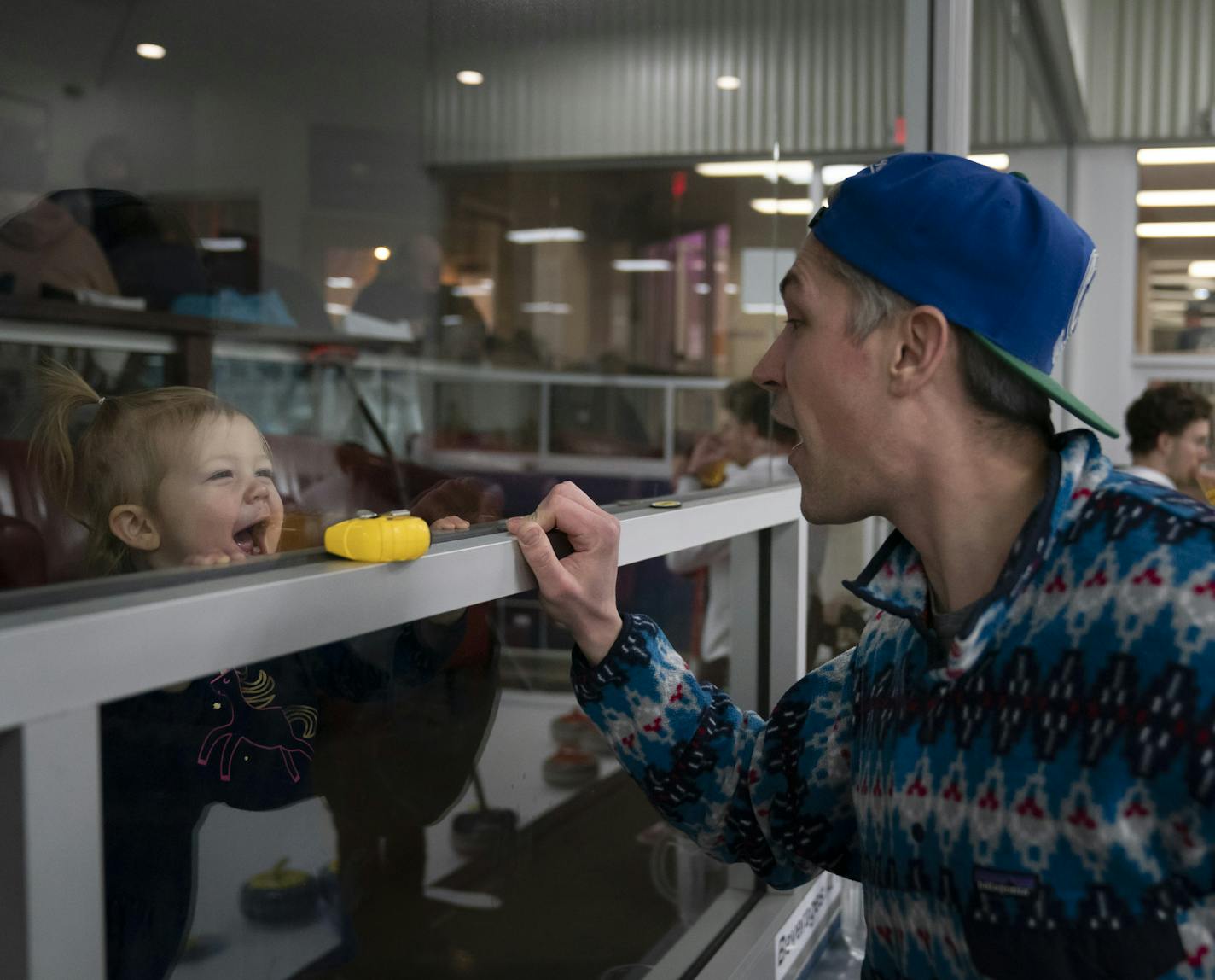 Robert Panger made a goofy face with his daughter Sullivan Panger as she was peering through the restaurant glass watching him curling with his curling league at the Four Seasons Curling Club in Blaine, Minn., Wednesday, January 29, 2020. ] RENEE JONES SCHNEIDER &#xa5; renee.jones@startribune.com