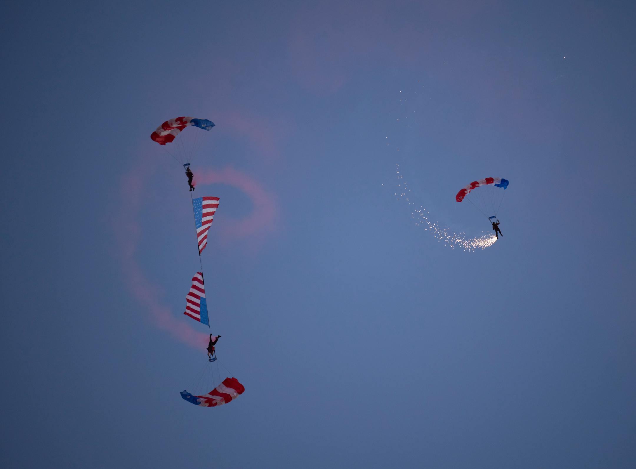 Skydivers landed on the field during the national anthem before the game at Huntington Bank Stadium.