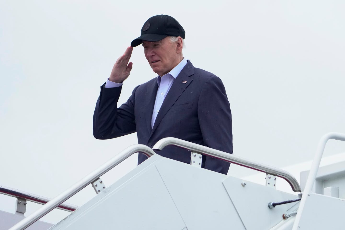 President Joe Biden salutes as he boards Air Force One as he leaves Andrews Air Force Base, Md., on his way to his Delaware home, Friday, April 19, 20