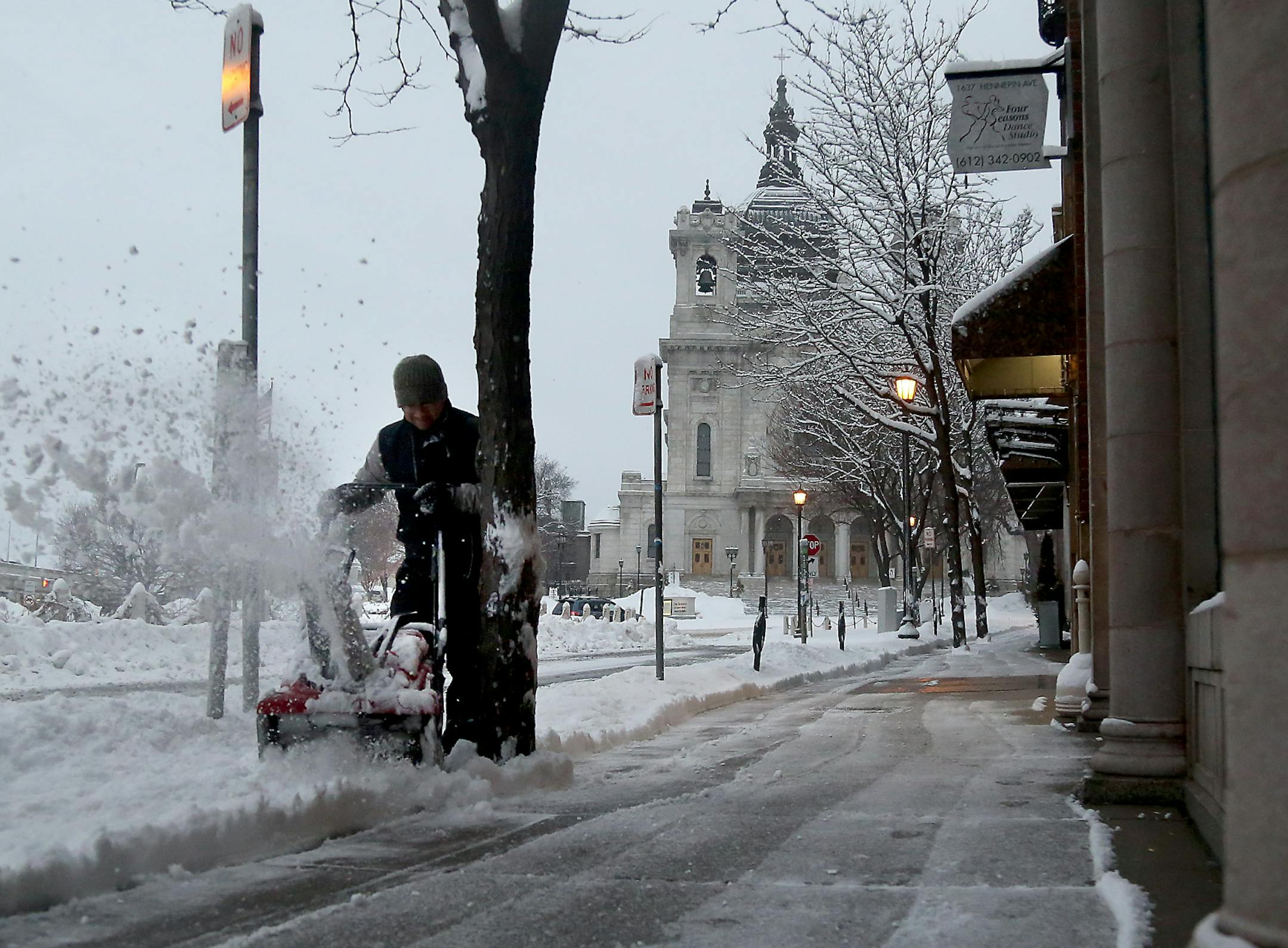 Maintenance worker Manny Lema, who is in charger of clearing snow from the Loring Park Quarters, pushes through fresh snowfall Tuesday, March 6, 2018, in Minneapolis, MN. A storm Monday afternoon and early Tuesday left about a half a foot in the Twin Cities and more out state.] DAVID JOLES • david.joles@startribune.com