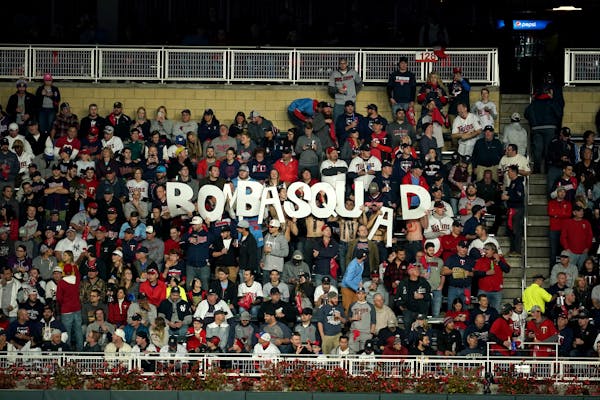 Fans held up a BombaSquad sign during last season's playoffs at Target Field.