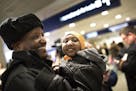 Mohamed lye holds his 4-year-old daughter Nimo as he was reunited with his wife Saido Ahmed Abdille and their other daughter Nafiso, 2, at Minneapolis