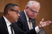Gov. Tim Walz looks to Attorney General Keith Ellison asks a question during a Board of Pardons meeting June 28, 2023 at the Minnesota Senate Building