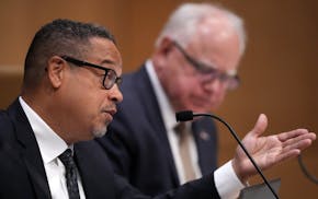 Gov. Tim Walz looks to Attorney General Keith Ellison asks a question during a Board of Pardons meeting June 28, 2023 at the Minnesota Senate Building