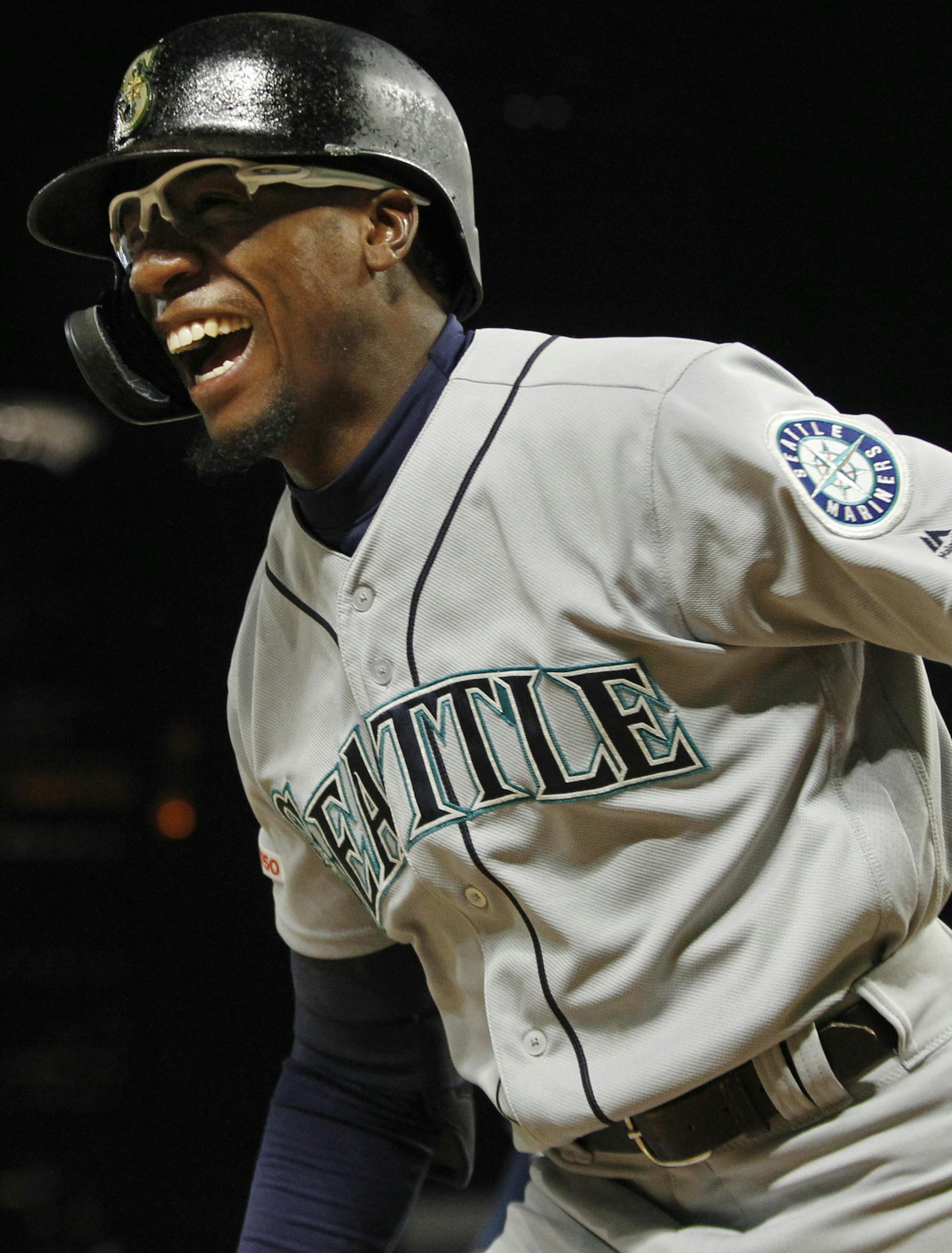 Seattle Mariners' Shed Long celebrates his three-run home run against the Minnesota Twins during the eighth inning of a baseball game Wednesday, June 12, 2019, in Minneapolis. (AP Photo/Bruce Kluckhohn)