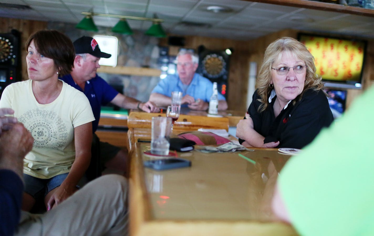 Harbor Inn Garrison Creek bartender Cheryl Garvin, right, and patron Pam Boyd, left, chat with other patrons following a Twin Cities TV news story that reported on Lake Mille Lacs and a potential early season hook and line walleye closing Wednesday, July 29, 2015, on Lake Mille Lacs.](DAVID JOLES/STARTRIBUNE)djoles@startribune.com The walleye crisis on Mille Lacs sparked a fresh round of fingerpointing, and fewer targets take more blame than the Mille Lacs Band of Ojibwe and the other bands who