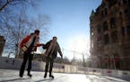 Stephanie Marrs, left, and Kris Fettig held hands as they slowly made their way around the rink at Winter Skate near Rice Park. The two hadn't been on
