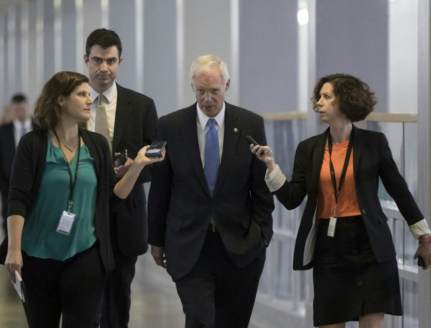 Sen. Ron Johnson, R-Wis., center, who has expressed opposition to his own party's health care bill, walks to a policy meeting as the Senate Republican legislation teeters on the brink of collapse, at the Capitol in Washington, Tuesday, June 27, 2017. Senate Majority Leader Mitch McConnell, R-Ky., needs 50 members of his conference to back the GOP health care bill in order to pass it.