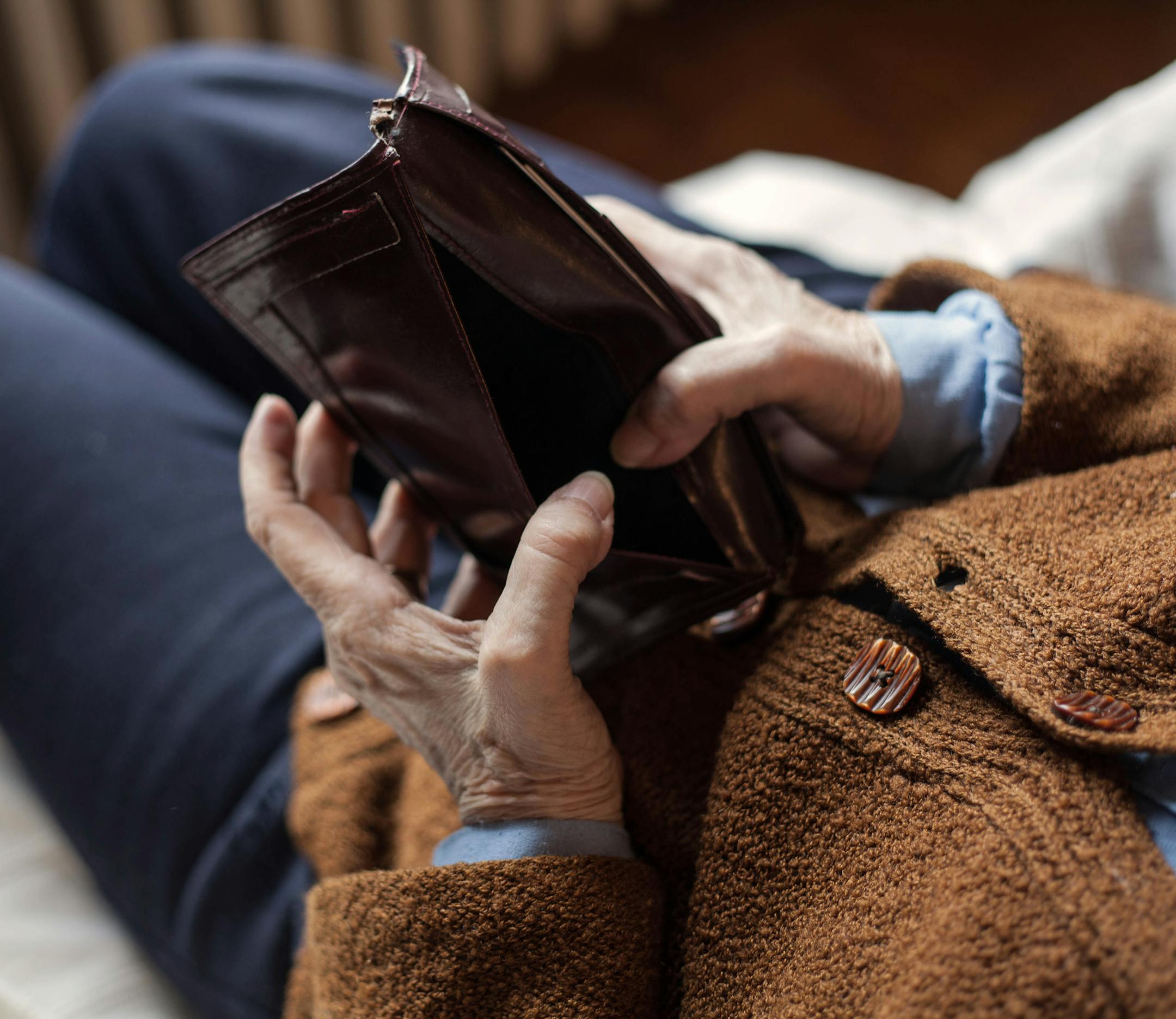 Old empty wallet in the hands .Vintage empty purse in hands of women . Poverty concept.