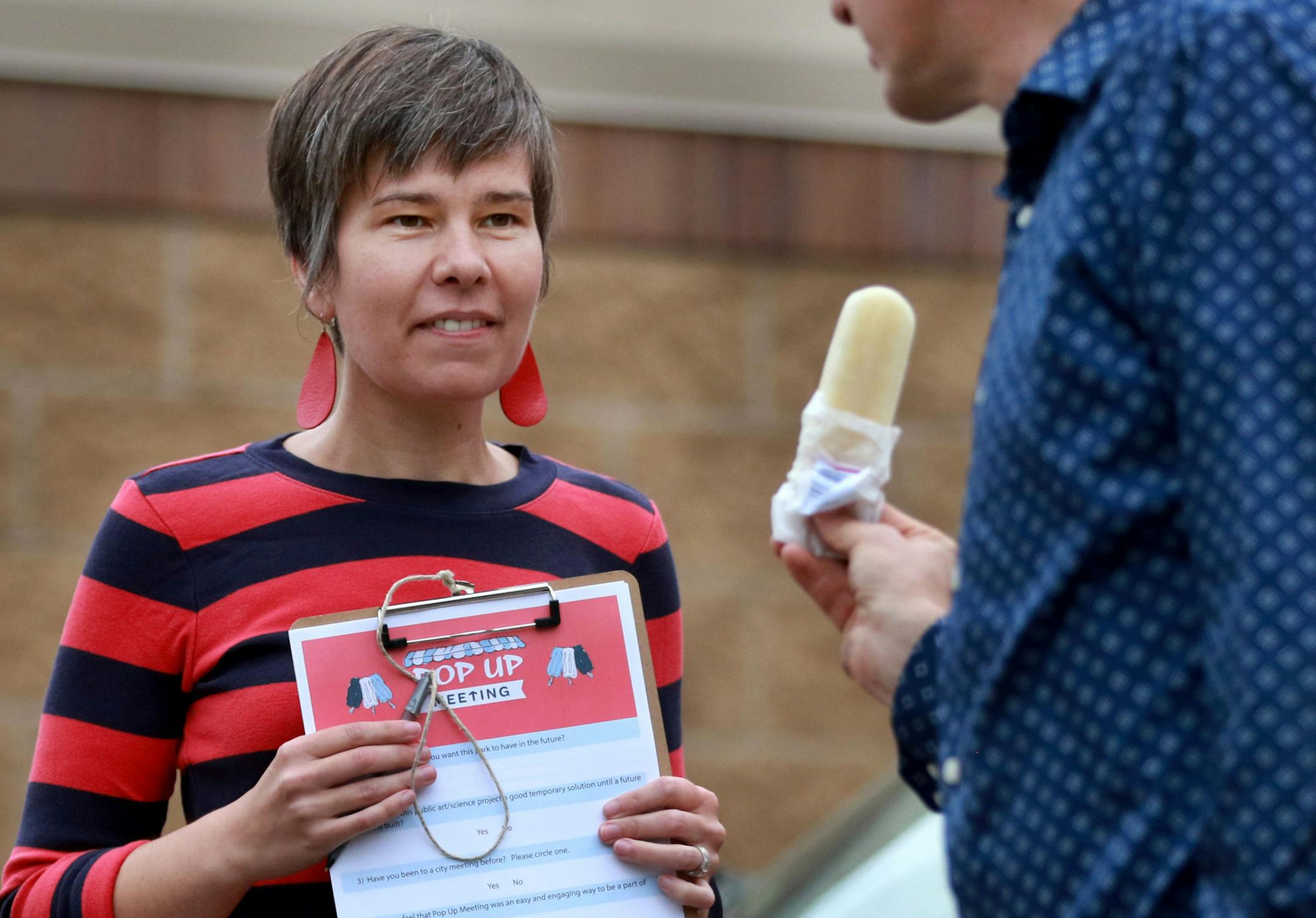 Pop Up Meeting truck, the two-year-old program and the brainchild of City Artist Amanda Lovelee, will be at its last event -- the year-end party for Urban Flower Field at Pedro Park Saturday, Sept. 24, 2016, in St. Paul, MN. Pop Up Meeting takes the public meeting to the public, and gives away popsicles as a reward for participating.Here, Lovelee, left, is seen at the event.](DAVID JOLES/STARTRIBUNE)djoles@startribune.com Pop Up Meeting truck and staff will be at the Year End Party for the Urban