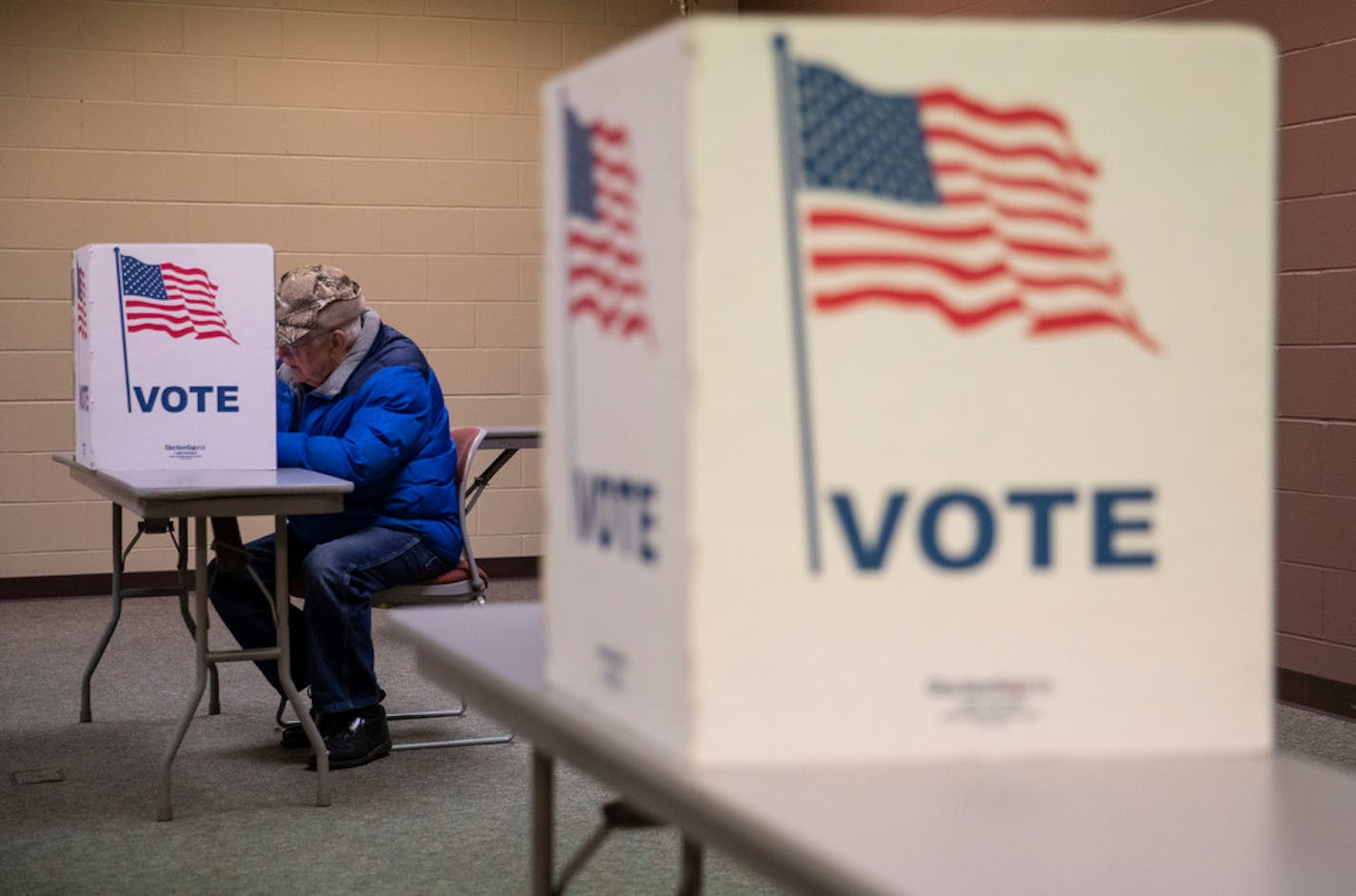 Bruce Kronlund cast his vote at the WITC Convention Center in Superior, Wis., on April 7. The Minnesota DFL has moved several congressional endorsement fights online.