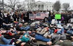 speaking up by lying down: Students took part Monday in a "lie-in" on the road outside the White House for 3 minutes at a time in an effort to symboli