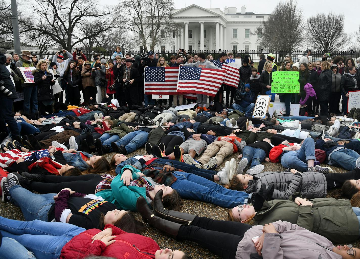 speaking up by lying down: Students took part Monday in a "lie-in" on the road outside the White House for 3 minutes at a time in an effort to symbolize how long it took Nikolas Cruz to gun down his victims in Parkland, Fla., last week.